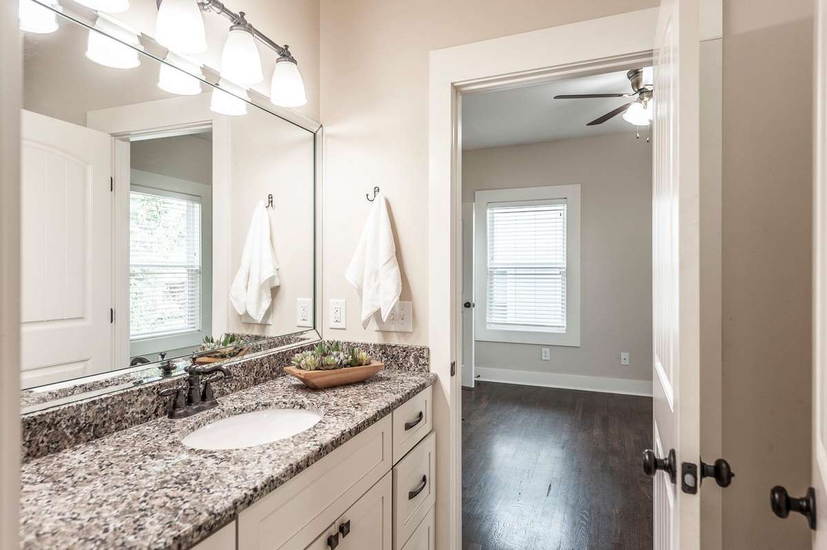 The Jack-and-Jill bathroom features granite countertops with double sinks, providing ample space for two.