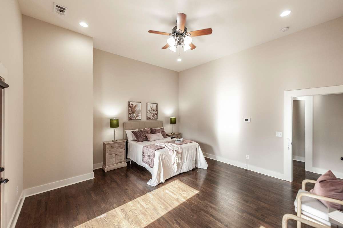 Large bedroom layout provides ample space for nightstands, dressers, and seating without feeling crowded.