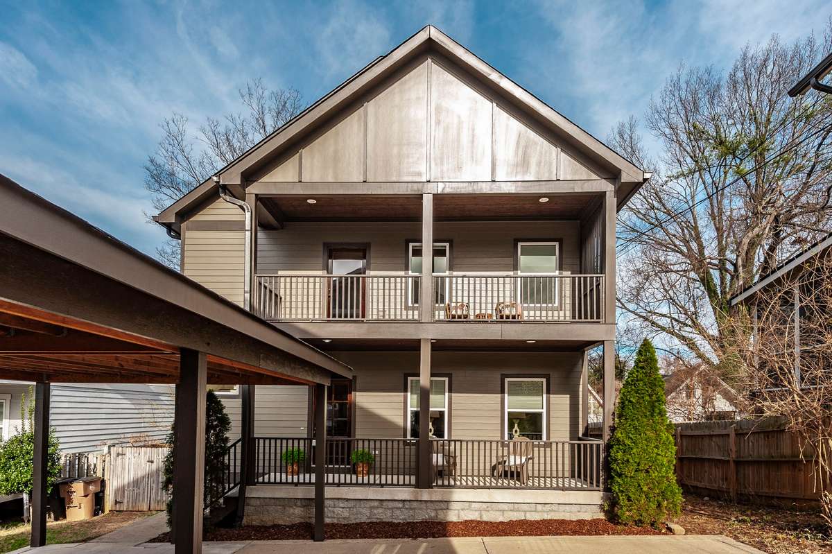 Classic front façade with mature trees nearby adds charm and a welcoming neighborhood feel.