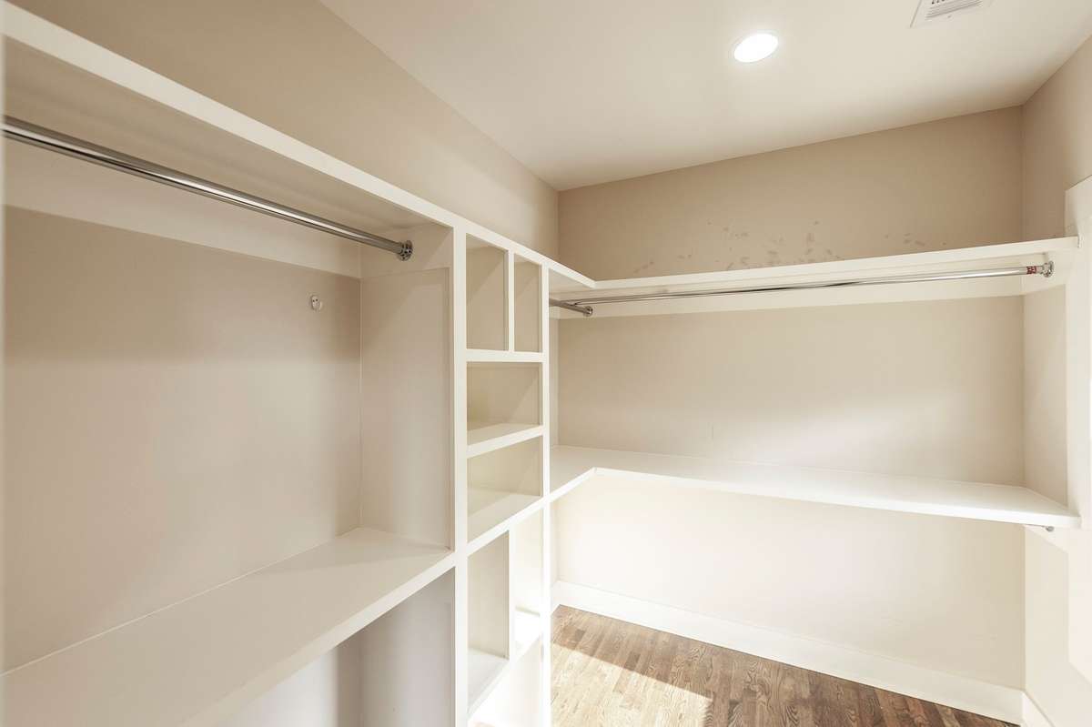 The walk-in closet is racked and ready for immediate use.