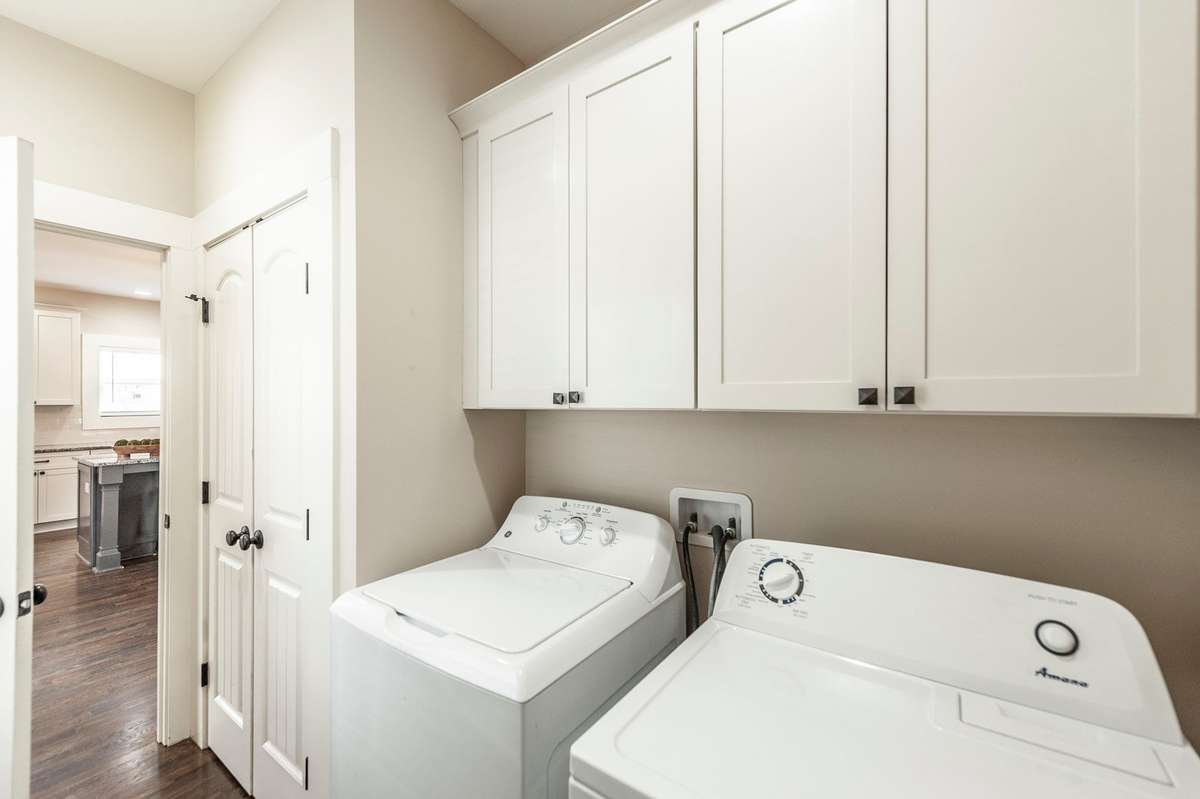 The utility room offers additional storage space, ideal for keeping household items neatly tucked away.