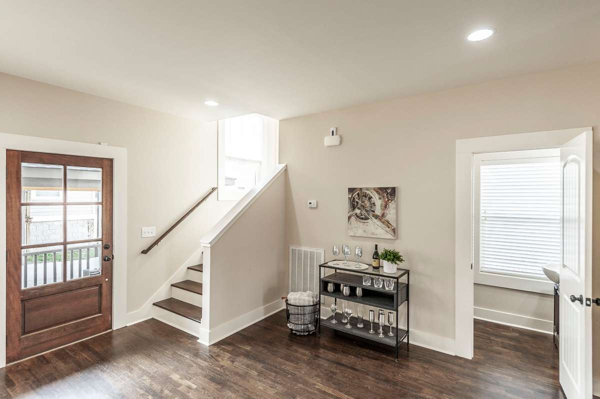 Flexible area near the dining space offers the perfect spot for a drop zone, sideboard, or serving station. Well-placed powder room on the main level adds everyday convenience for guests and daily living.