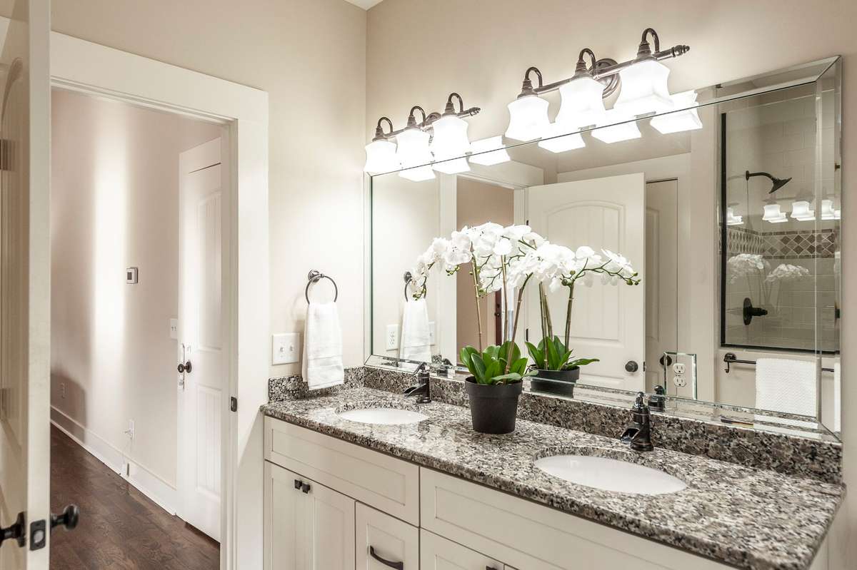 Double sinks with granite countertops provide ample space for daily routines.