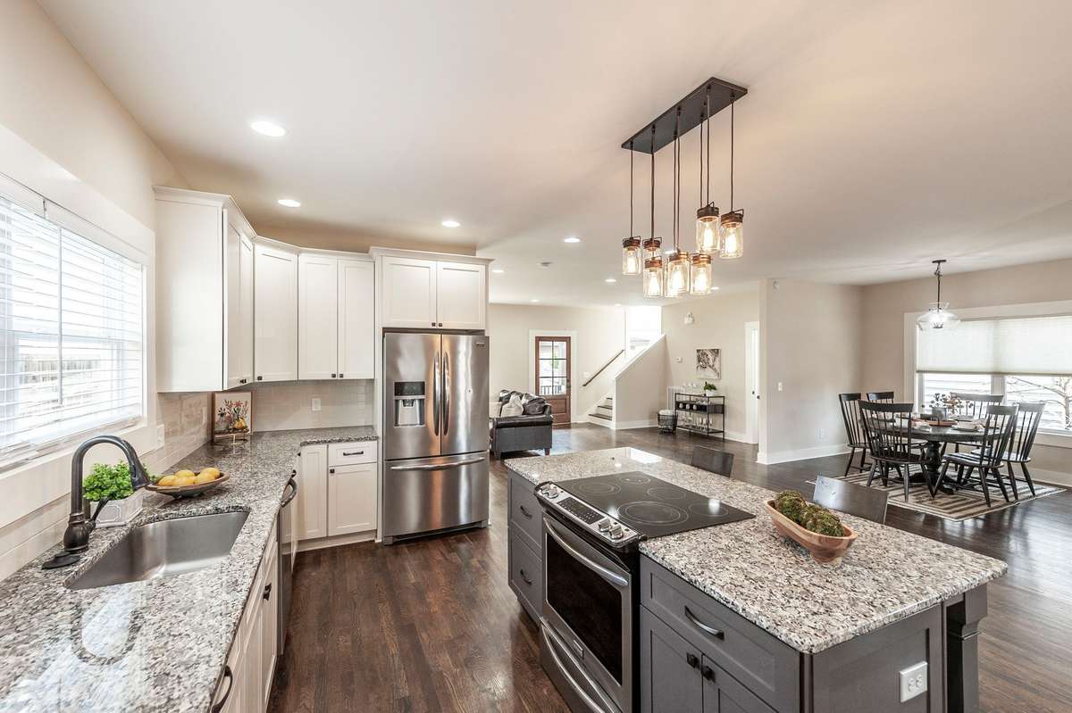 Granite countertops paired with a classic tile backsplash create a clean and timeless kitchen design.