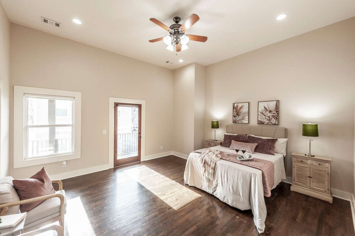 The spacious primary suite easily accommodates a king-sized bed with room to spare for dressers and additional furniture.