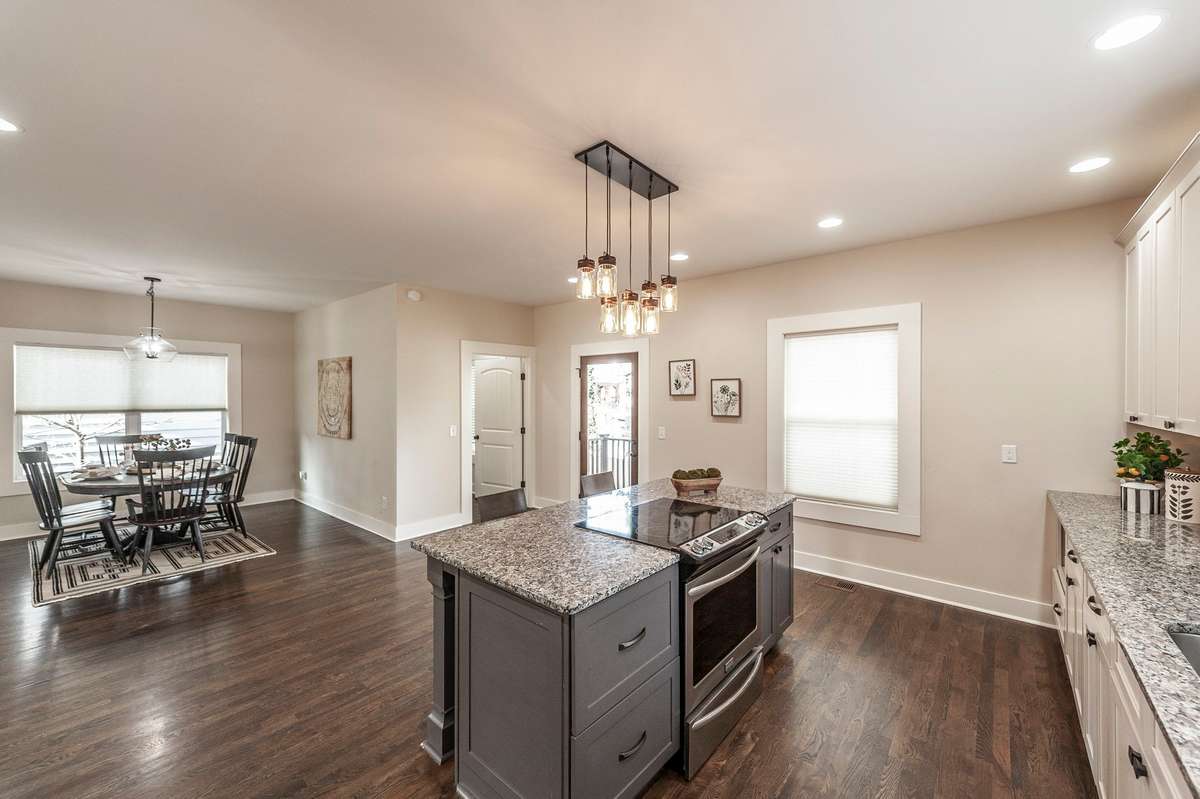 The oversized island provides generous prep space and seating, making it ideal for casual dining and entertaining.