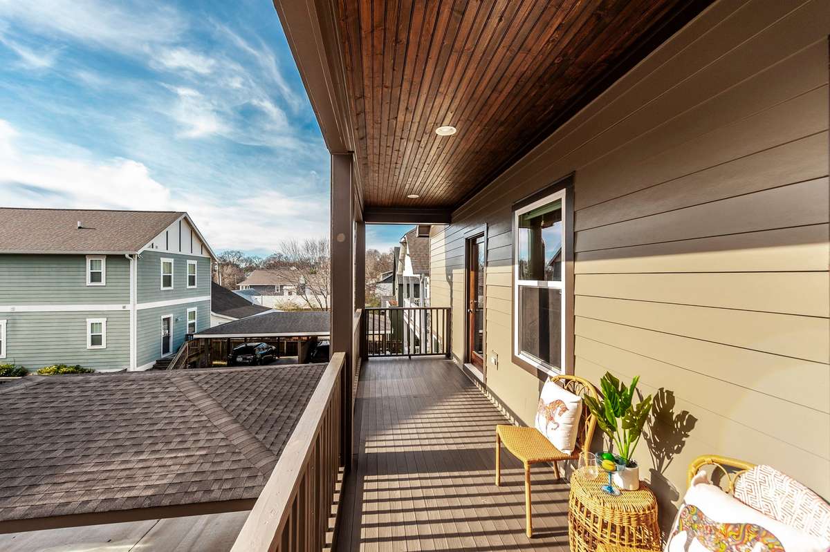 The upstairs covered deck is perfect for enjoying morning coffee or unwinding in the evenings.
