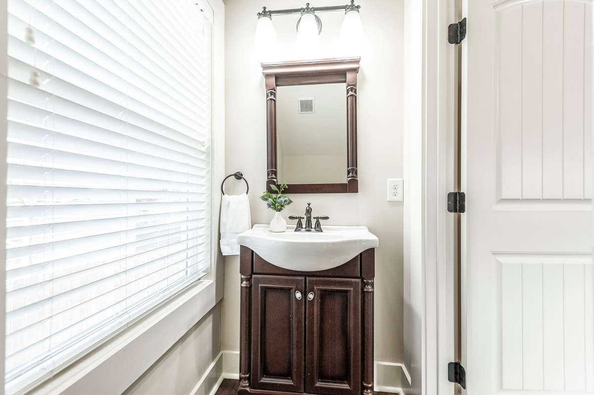 The well-placed powder room on the main level adds everyday convenience for guests and daily living.