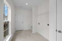 Rear Foyer/Entry into mud room with Laundry