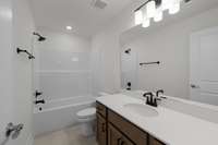 Hall bath with tile floor and quartz counter tops included