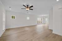 Family room with Ceiling fan included.  Lots of windows for natural lighting.  Laminate flooring included on first floor main.