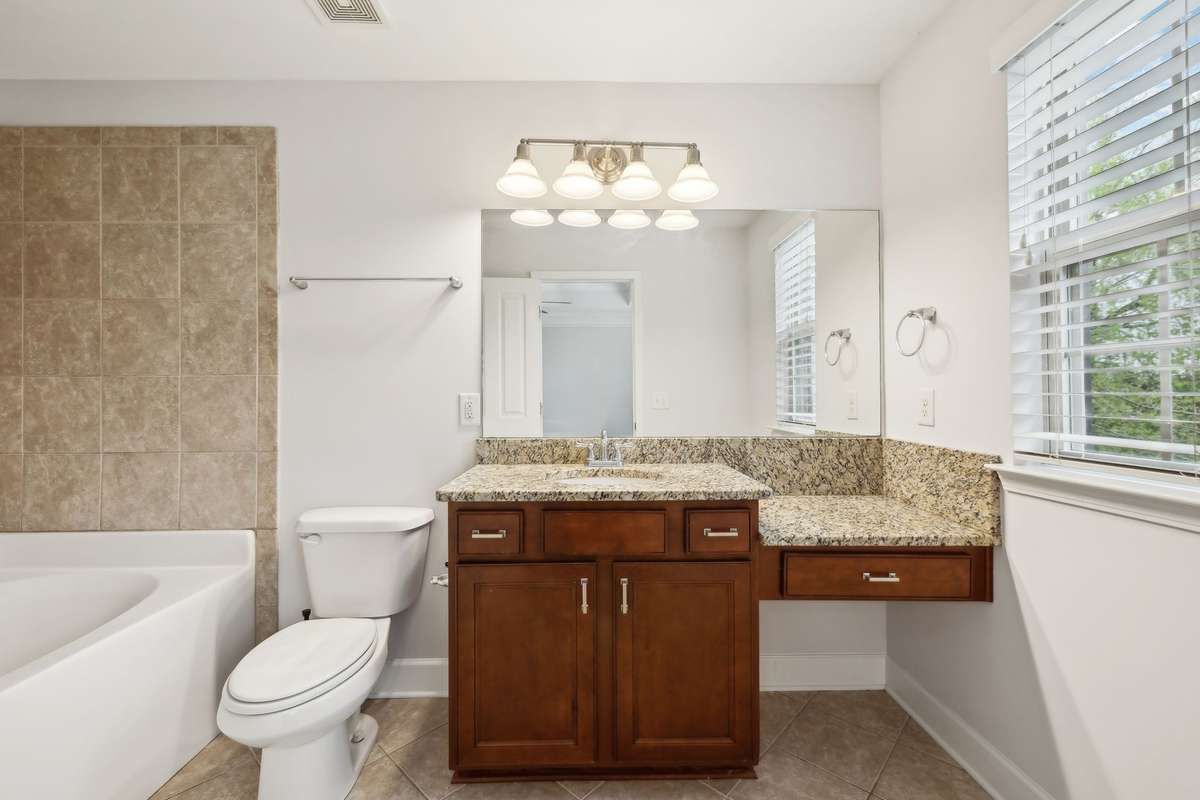 Primary bath with granite countertops and soaking tub