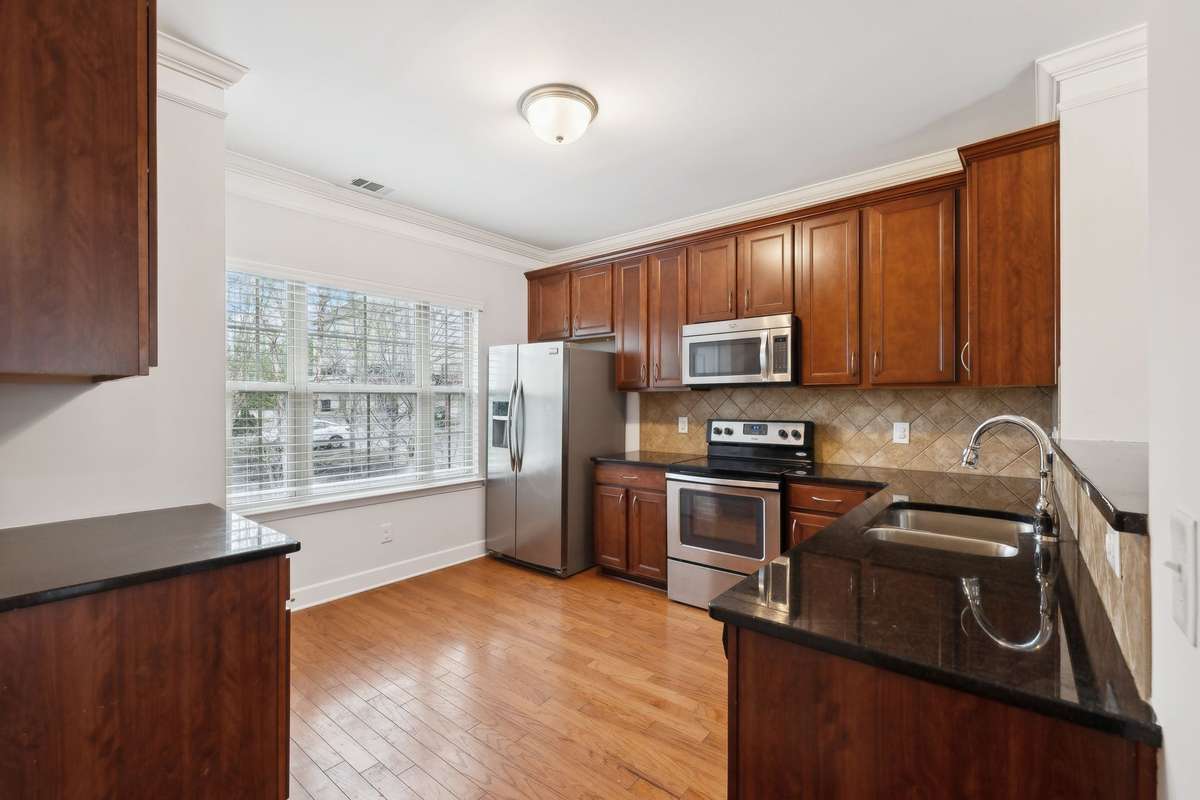 Kitchen comes equipped with stainless steel appliances and granite countertops