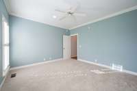 Spacious bedroom on main level with plantation shutters