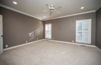 Primary suite has new plush carpet, plantation shutters and reading lights