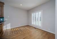 Breakfast area off the kitchen-plantation shutters and recessed lighting