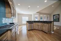 This kitchen features beautiful cabinets, black granite and tile backsplash with the perfect pop of color.