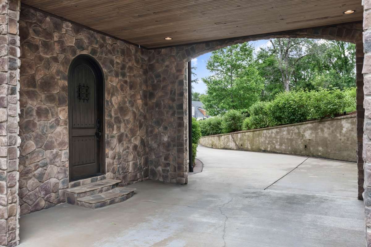 Porte-cochere that accesses one of the two-car garages.