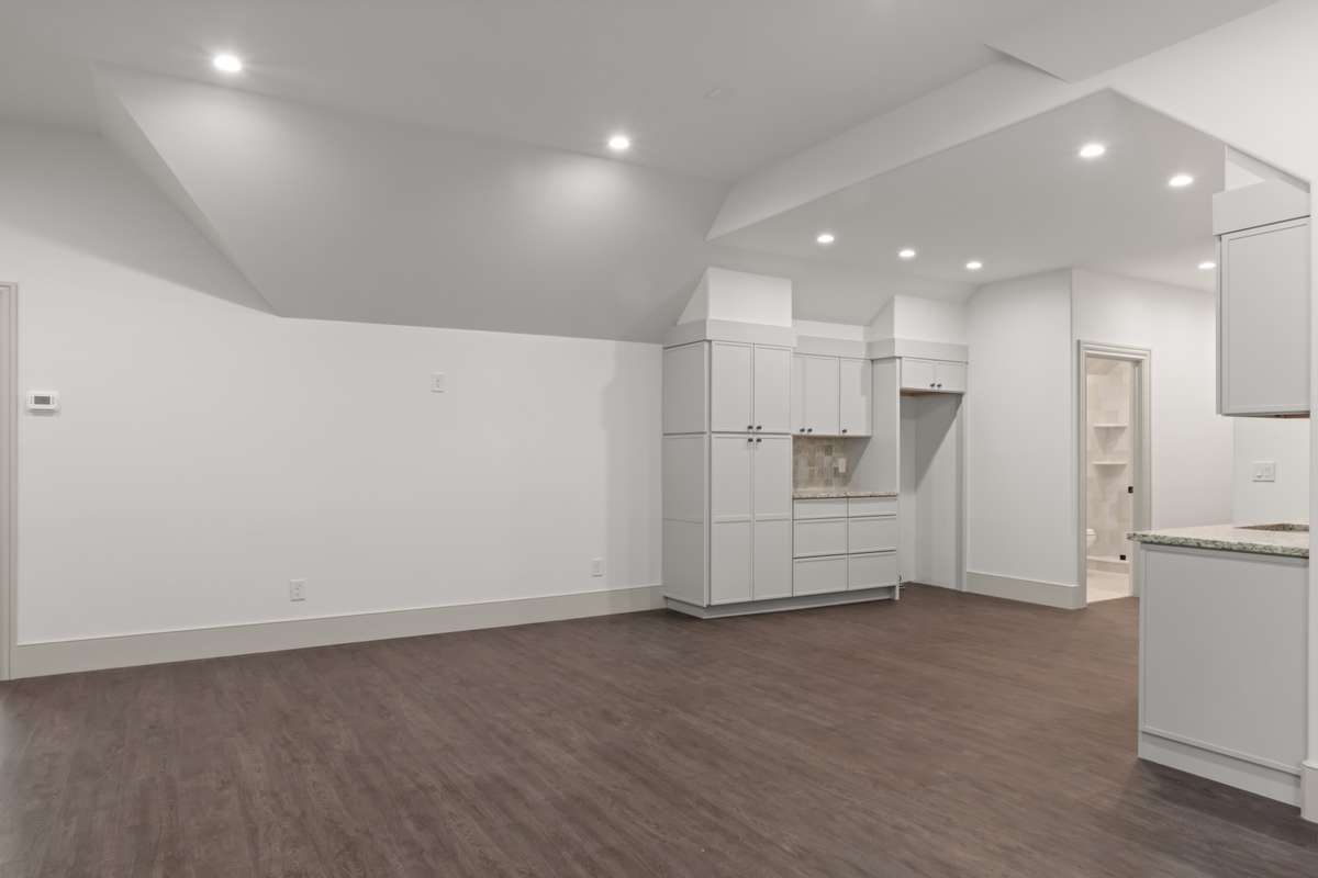 Kitchen and patrol living area of attached apartment. Note the high ceiling.