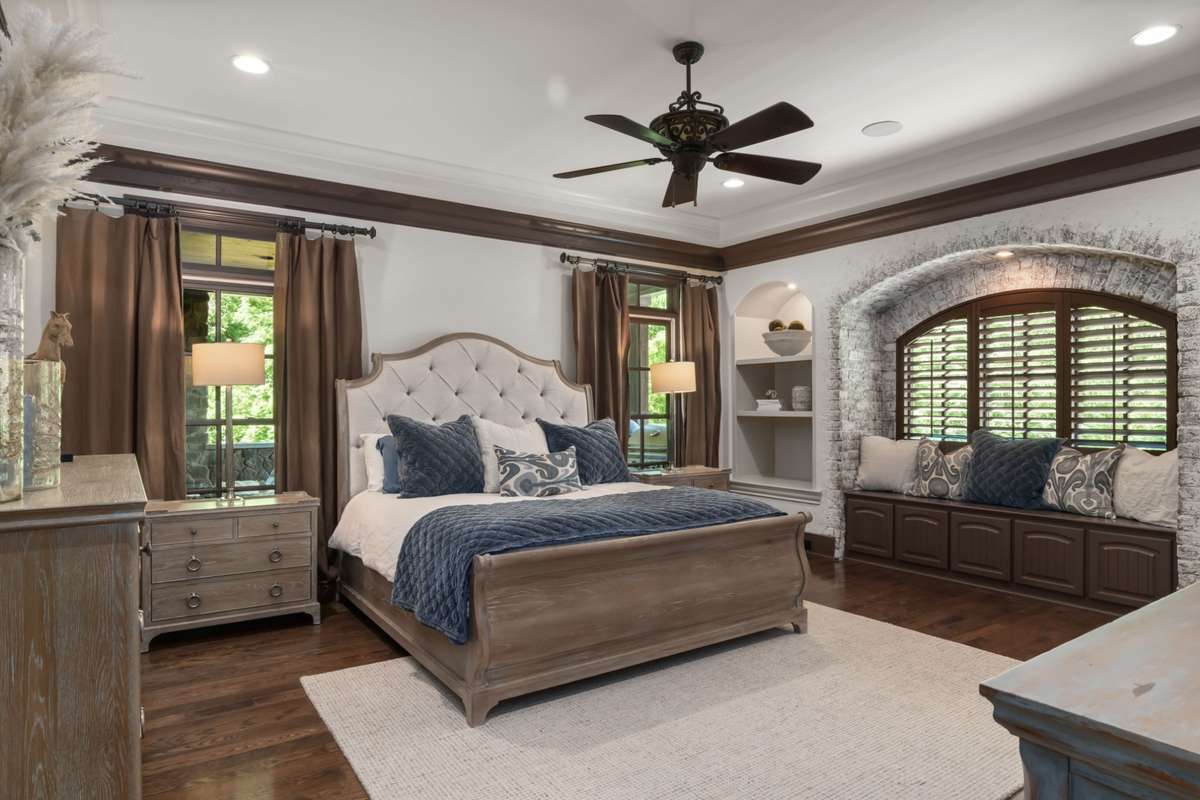 Primary suite on the main floor. Elegant mill work and exposed brick arched window set the tone.