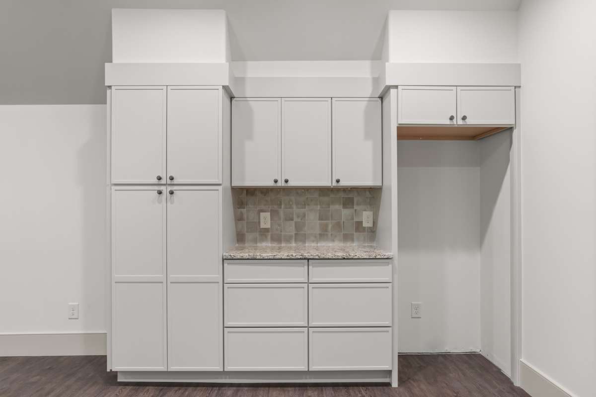 More cabinets and space for full-size refrigerator.