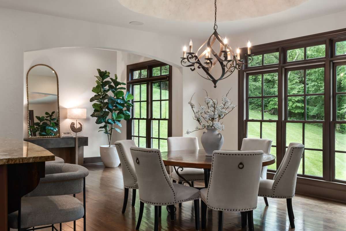 Breakfast nook (more like a room than a nook) connects to the kitchen and overlooks the private back yard and woods beyond. The background space can be office/catch-all or gallery. Leads to back stairway.