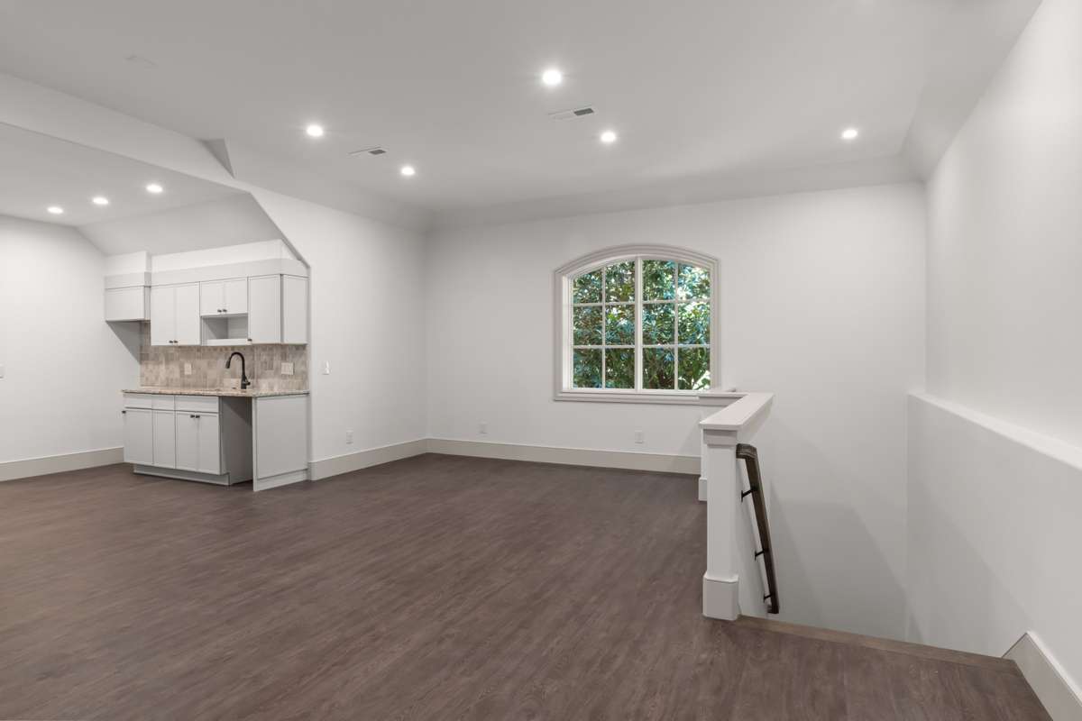 Alternate view of the living area in the attached apartment. The stairs to the right are one of two private entrances, it leads directly to the garage.