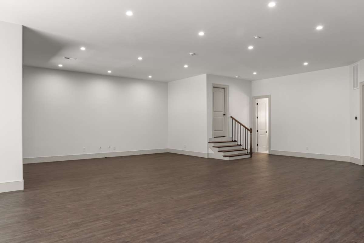 Alternate view of the lower level bonus room. Plumbing is stubbed in the far wall for future kitchen area.