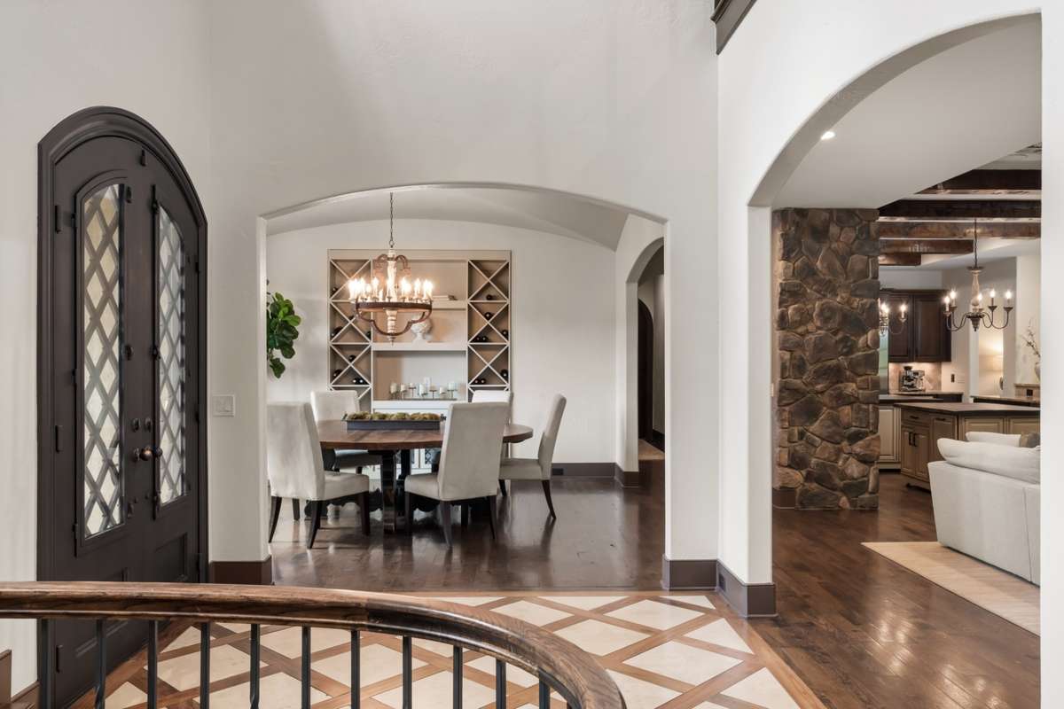 The foyer from the stair landing looking toward the formal dining room and family room.