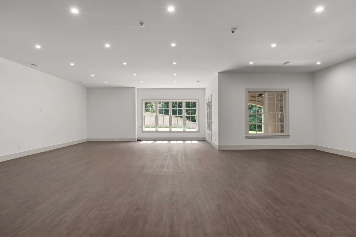 Newly finished bottom level bonus room. Leads to the back yard. The window to the right overlooks a covered patio.