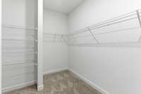 The main-level owner’s suite offers convenience and comfort with a large walk-in closet, separate tub and shower, and peaceful views of the backyard.