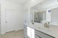 The main-level owner’s suite offers convenience and comfort with a large walk-in closet, separate tub and shower, and peaceful views of the backyard.