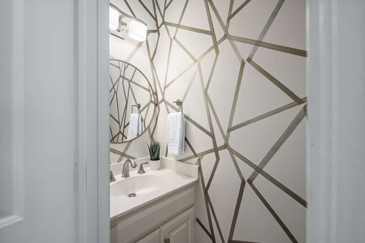 The powder room on the first floor features designer wallpaper.