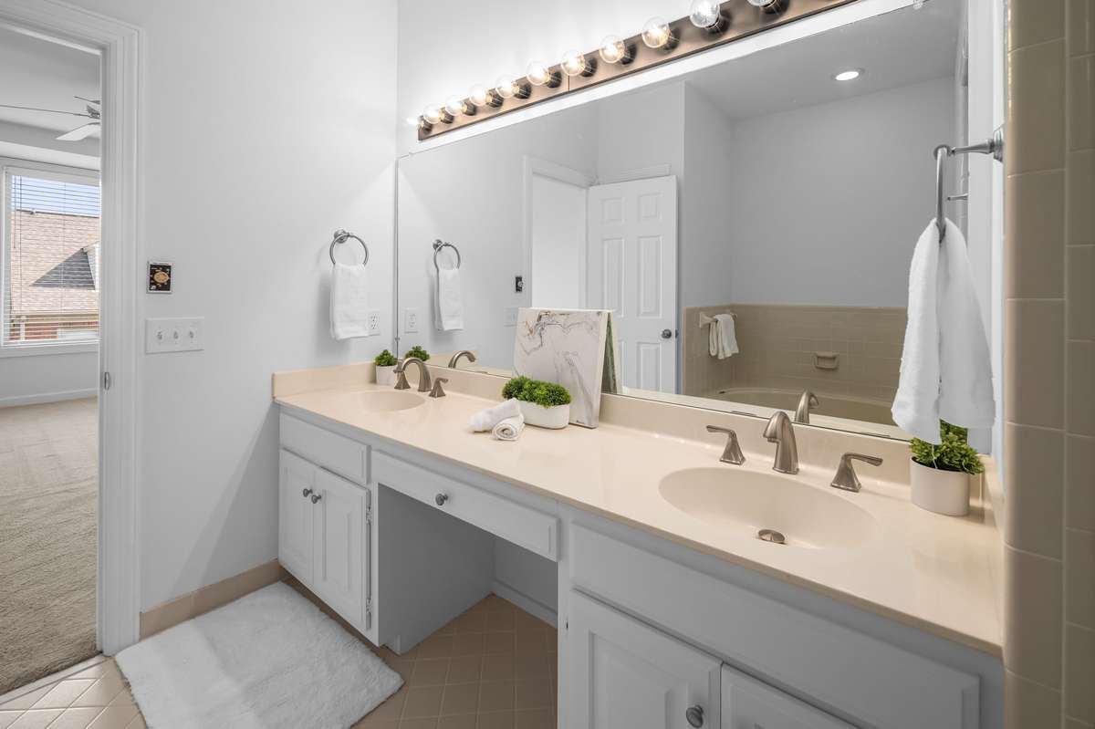 An oversize double bowl vanity in the primary bathroom makes it easy to get ready in the morning.