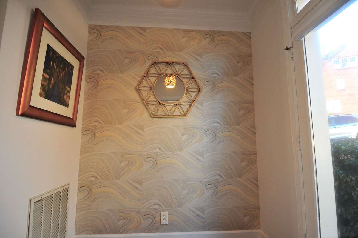 The entry is large enough for a console table or shelving to make an upscale drop zone. There is also a coat closet. The transom window over the front door provides plenty of natural light.