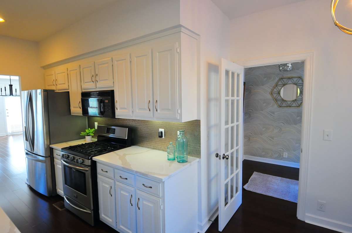 The kitchen is accessed through the entry or the dining room. The cabinets have been recently painted and quartz countertops were added in December.