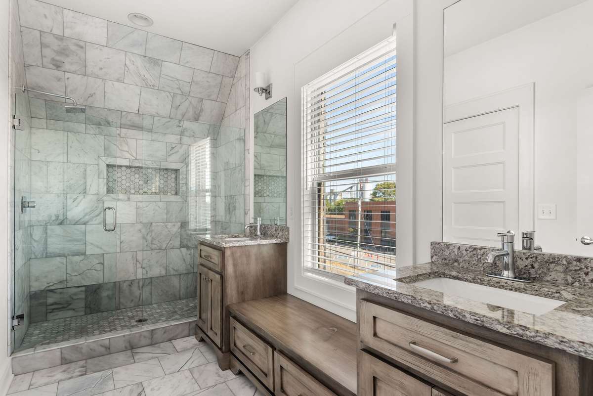 Master bathroom features marble flooring and shower