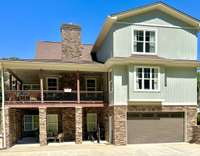 Covered Deck + Lower Patio - Entertain year-round with a covered deck featuring a fireplace, plus a second seating area below for gatherings or quiet relaxation.