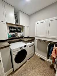 Laundry room provides tons of extra storage, new appliances, and new cabinets.