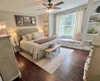 Master bedroom has built-in cabinets, natural light, and a window seat that says, "sit here and enjoy your morning coffee"!