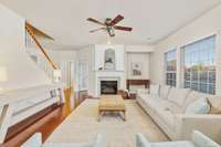 Spacious living room with wall of windows, cubby that is a great spot for books and a gas fireplace to keep you cozy