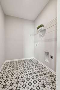 Oversized Laundry Room on the Main Level. Not pictured: Washer & Dryer will remain!