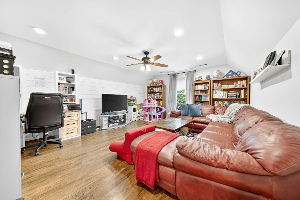Bonus room upstairs with hardwood flooring and lots of recessed lighting.