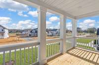 Covered Front Porch off of upstairs Den. This home's unique feature is 4 covered porches.  Two face the front and 2 in the back.