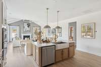 A unique feature of the Lockwood floorplan is as you look past the island, the living room ceiling vaults. This puts the focus on the exterior wall and fireplace.