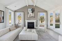 Vaulted living room overlooks mature tree line. Covered Balcony is accessible from livingroom.