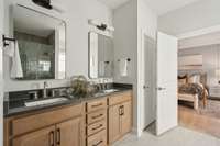 Double sinks. Cabinet color in this model is very similar to actual home. Counterops will be light white/off white quartz. Modern mirrors and mid century lighting fixtures.