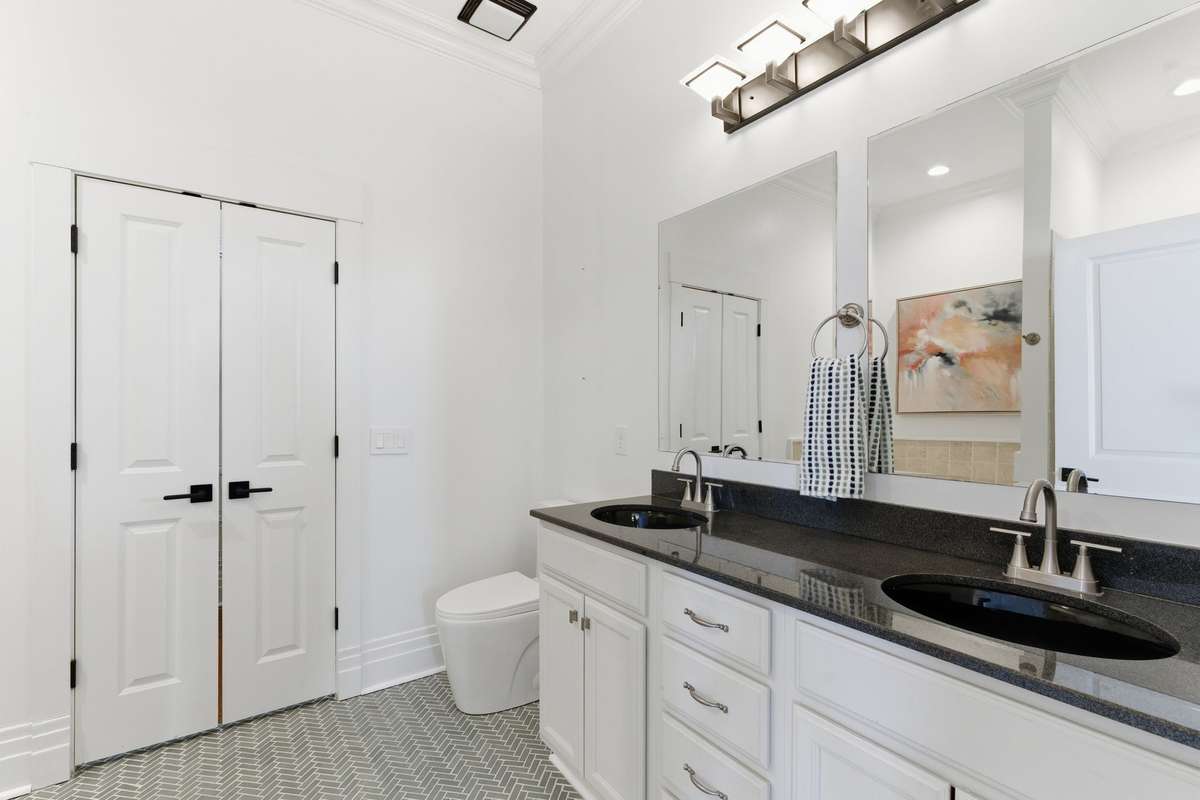 Primary bath with dual vanities, walk in shower, and soaking tub.
