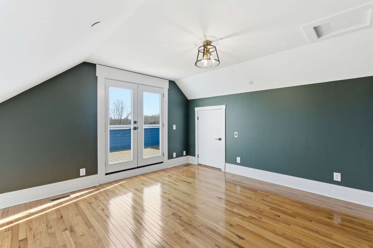 Flex space off of Primary Bedroom. Perfect for a nursery, office, or additional living space. Double doors leading to private balcony.
