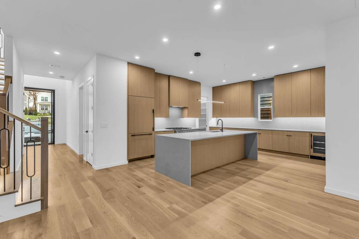 Gorgeous modern kitchen with cabinet front appliances and expansive counter space